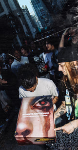 Giveaway winner holding up an Optimistic Adolescence box he caught in the air during the Miami Art Basel Giveaway